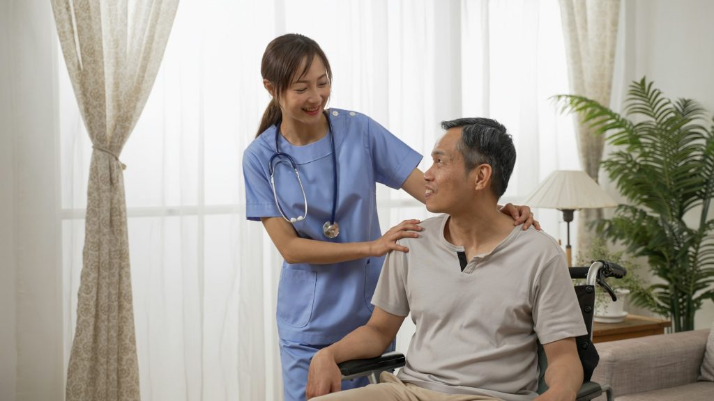 nursing aide talking to disabled grandfather